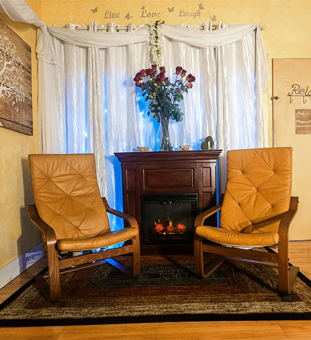 A serene spa lounge with comfortable chairs and a warm fireplace at Hands On Wellness Day Spa in Commack, Long Island.