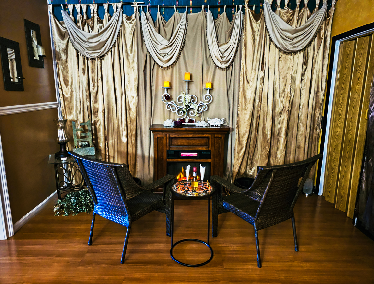 A cozy couples suite with a fireplace at Hands On HealthCare Massage Therapy in Commack, Long Island.