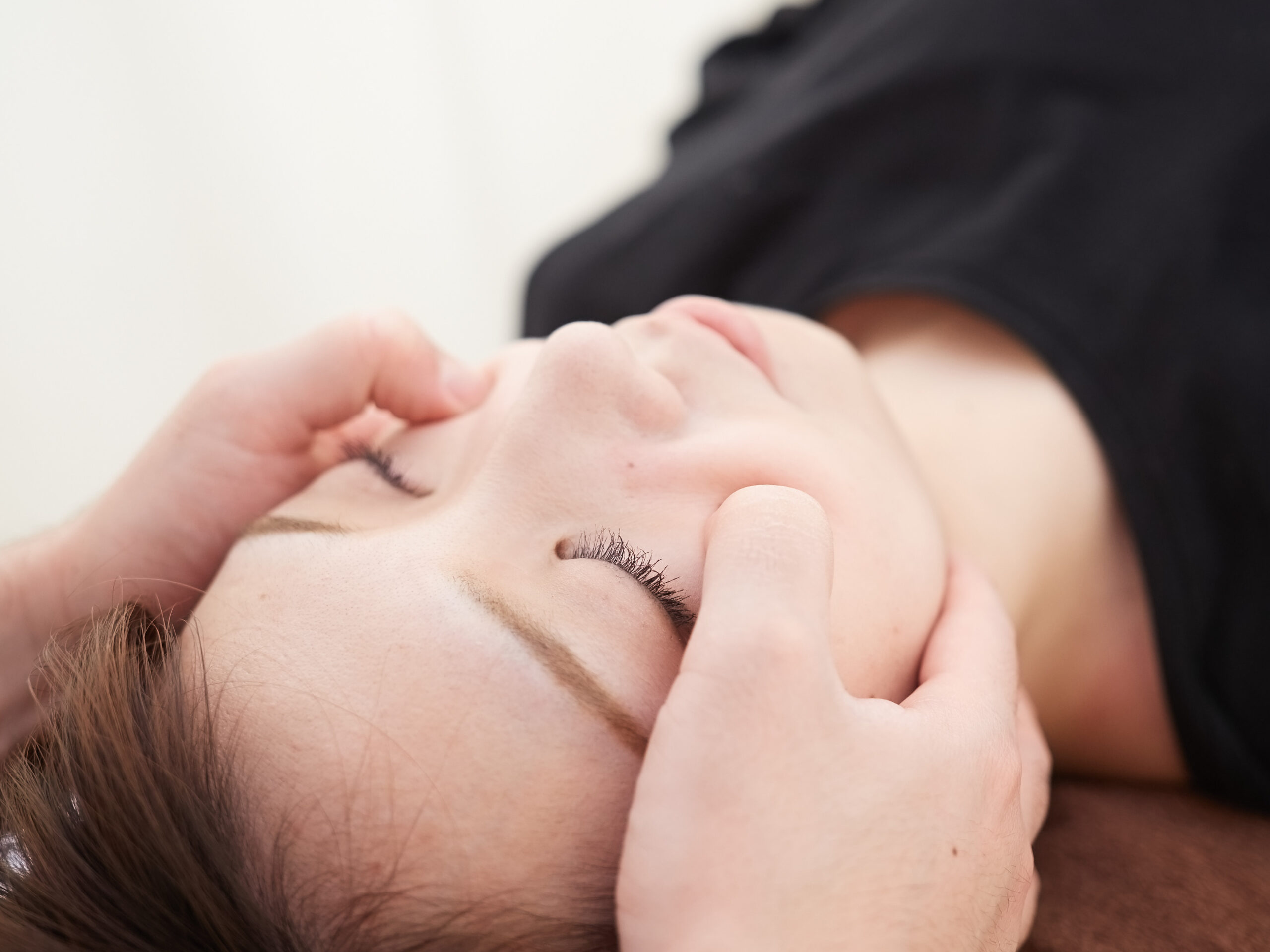 A client enjoying a relaxing facial massage at Hands On HealthCare Massage Therapy in Commack, Long Island.