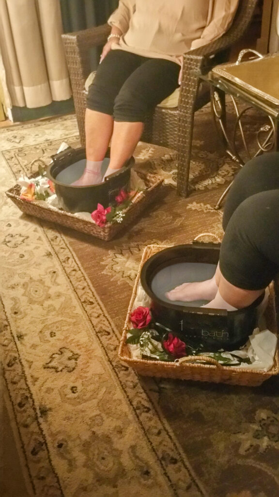 A group enjoying relaxing foot soaks during a spa party at Hands On HealthCare Massage Therapy in Commack, Long Island.