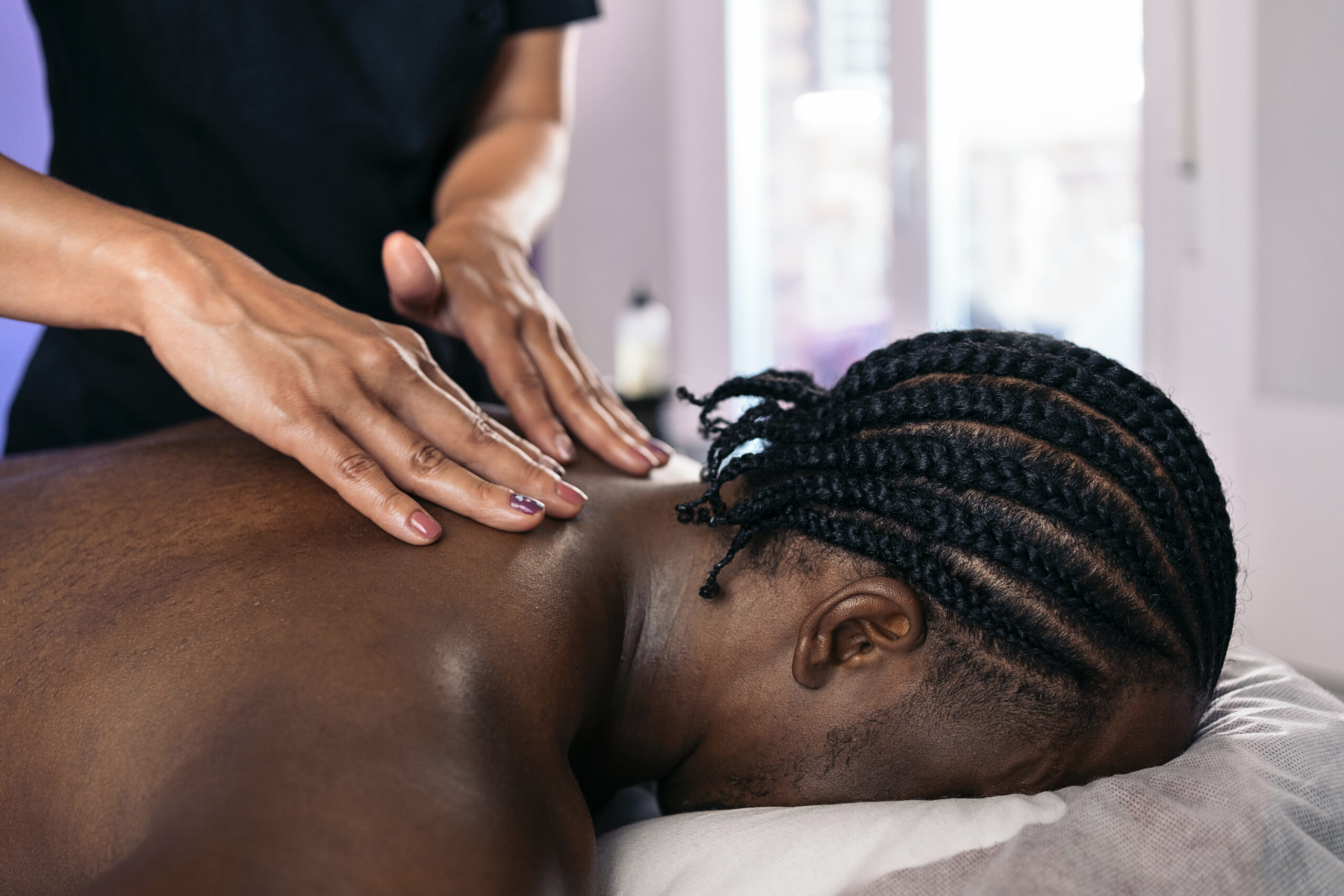 A man receiving a massage at Hands On HealthCare Massage Therapy in Commack, Long Island, highlighting the process before, during, and after the session.