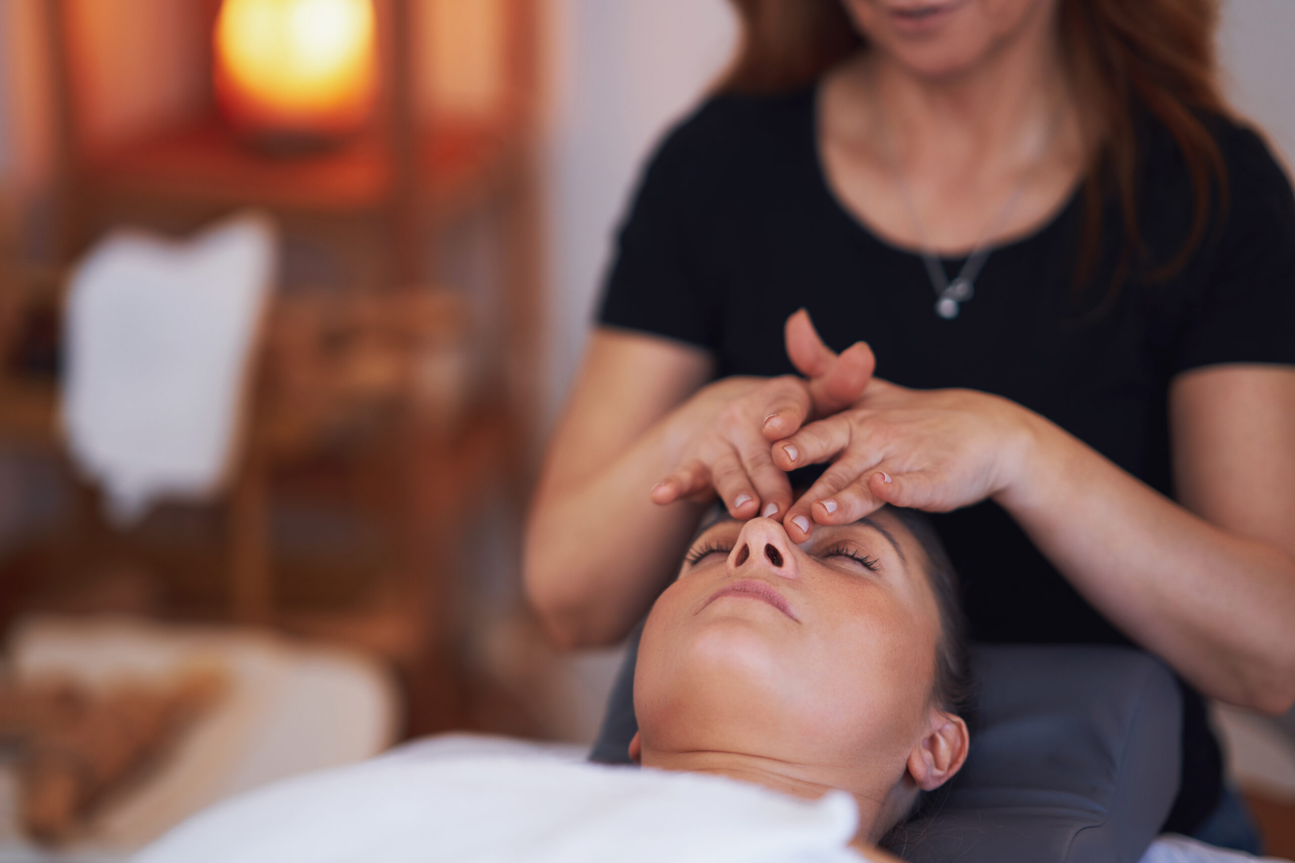 A woman receiving a massage at Hands On HealthCare Massage Therapy in Commack, Long Island, illustrating the process before, during, and after a session.